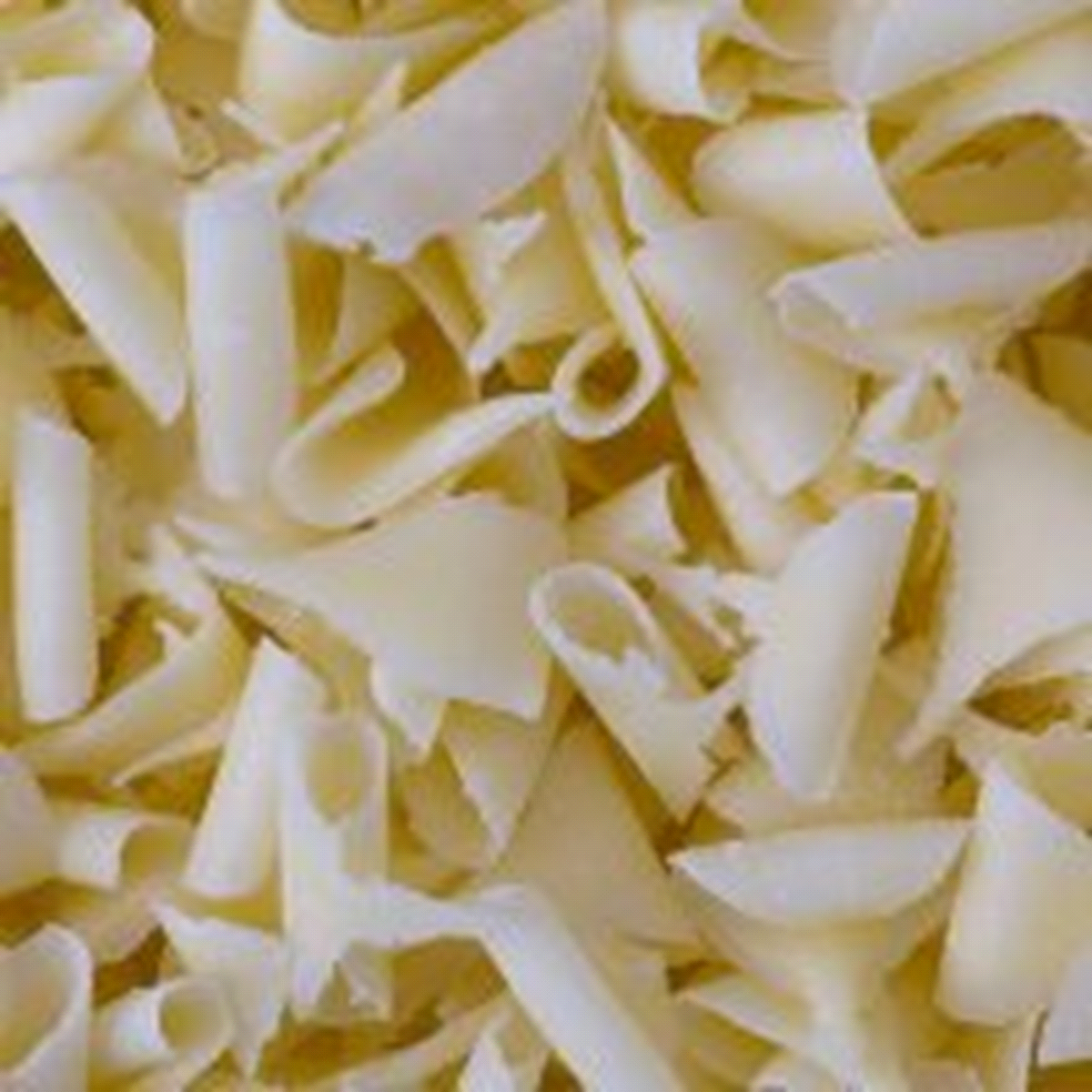 Decorazioni in cioccolato bianco modellate a ricciolo. Vaschetta da 700 g. 